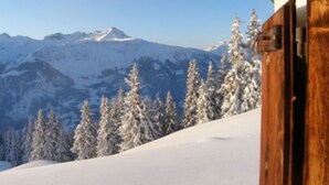 A snowy mountain landscape with a wooden structure partially visible. - Tegia Veglia / Erlebnisalp Glivers, Sumvitg, (Sumvitg), 75002B by Interhome (Cumpadials)