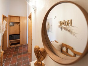 A room with a wooden wardrobe, a mirror, and a bed with a wooden headboard. - Cresta 54, Obersaxen-Misanenga, (Obersaxen), by Interhome (Obersaxen Affeier)