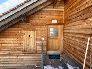 A wooden cabin with a sloped roof, a wooden door, and a small window. - Haus Vicasa, Andiast, (Andiast), 59003B by Interhome (Andiast)