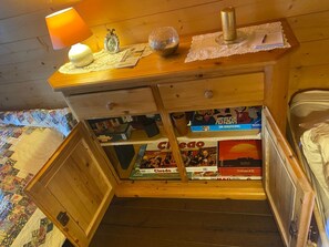Un taulell de fusta amb una làmpada a sobre, una esfera de vidre decorativa i una nostra de punt.