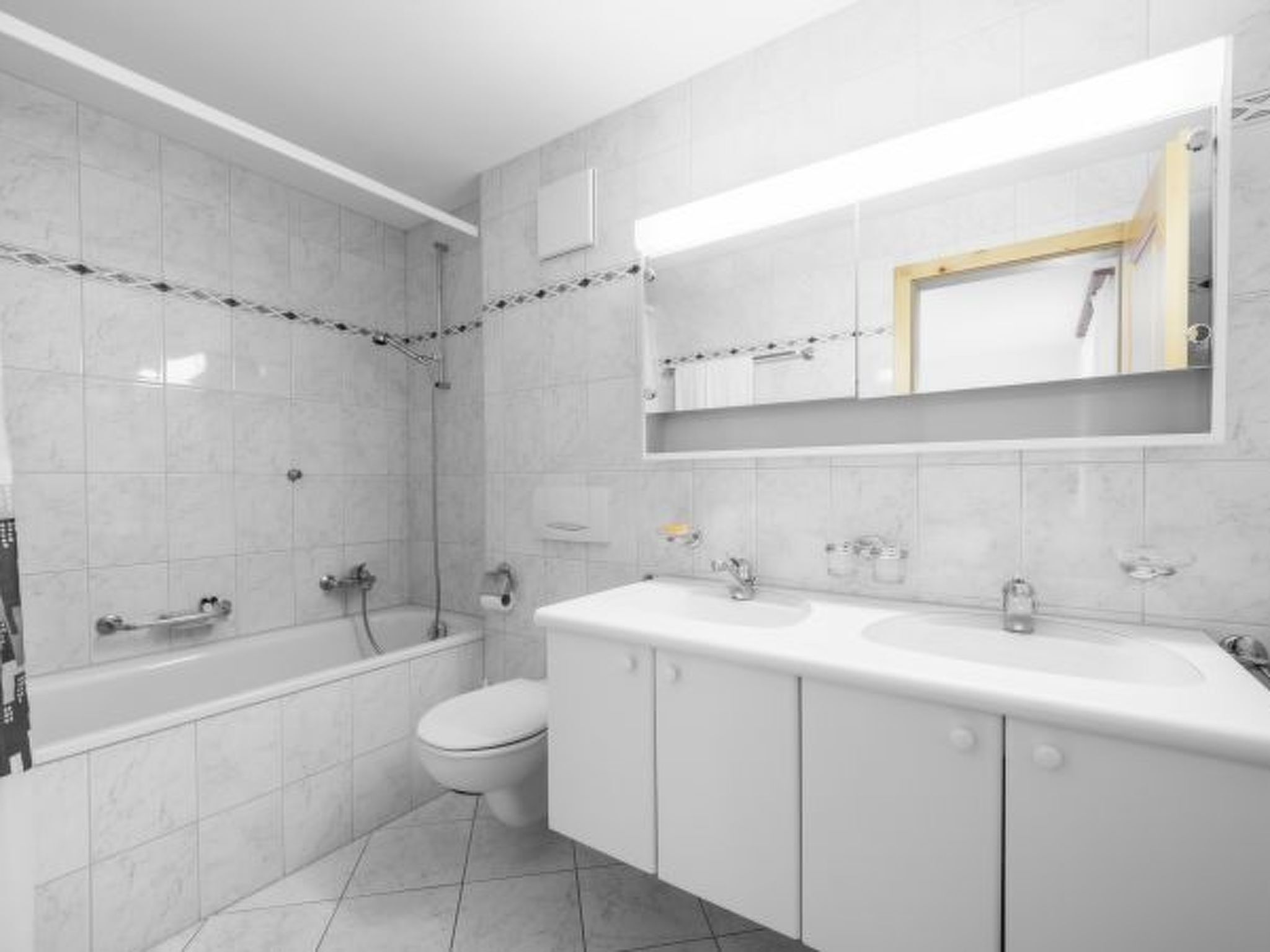 Une salle de bain moderne équipée d’une baignoire, de toilettes et d’un grand meuble-lavabo avec un miroir.