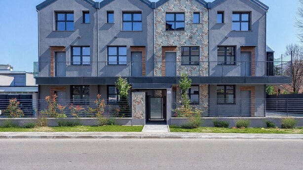 A modern multi-story building with a symmetrical facade, large windows, and a central entrance. - Flower Residence - Appartamento Begonia (Lissone)