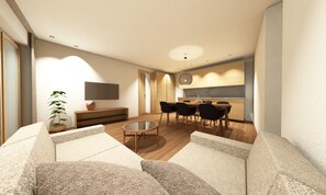 Un salon moderne comprenant un canapé, une table basse, un téléviseur et un coin repas avec des chaises et une table.