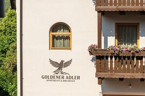 A building with a sign for 'GOLDENER ADLER APARTMENTS & BREAKFAST' featuring a bird logo. - Apartment 'Smart 5' with Balcony and Breakfast Included - new 2026 (Trodena nel Parco naturale)