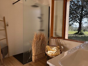 A room with a sliding door, a wicker chair, a wooden ladder, and a view of a tree outside. - MAS DU PERIGOULIER by Interhome (Carces)