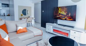 A modern living room with a sofa, TV, and entertainment unit. - Marvel Quest Newly Furnished 1 bedroom unit (Nairobi)