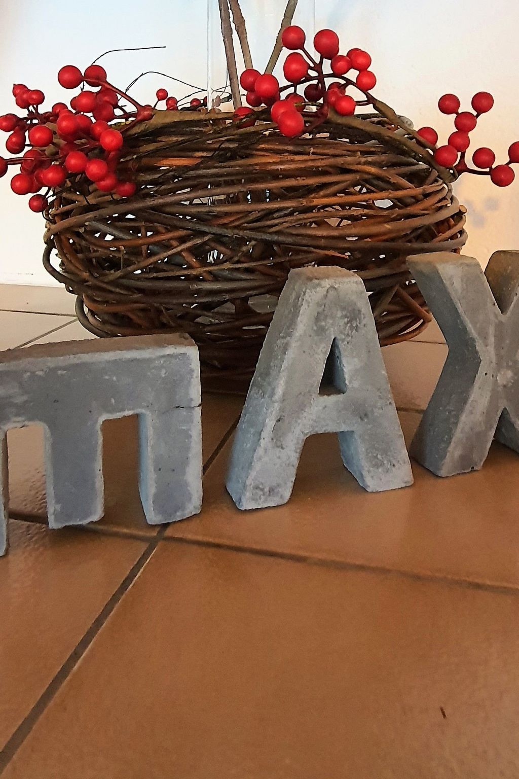 A woven basket with red berries and the word 'TAX' in large letters on the floor.