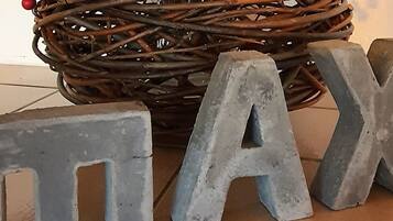 A woven basket with red berries and the word 'TAX' in large letters on the floor.