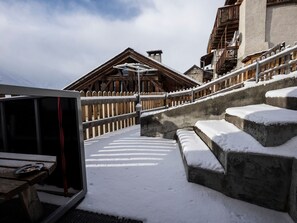 A snow-covered staircase leading to a wooden building with a sloped roof, possibly a chalet or lodge. - Archas 202A, (Sent) by Interhome (Sent)