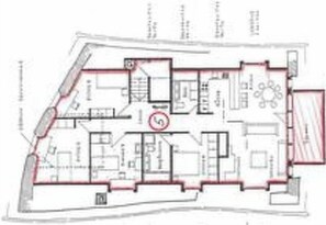A floor plan of a hotel with multiple rooms, a central lobby, and a dining area.