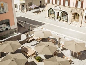 A hotel with outdoor seating and a visible restaurant sign. - Hotel Maistra 160, (Pontresina), by Interhome (Pontresina)