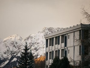 A building with a modern architectural style, featuring a flat roof and a symmetrical facade with evenly spaced windows. - Hotel Maistra 160, (Pontresina), by Interhome (Pontresina)