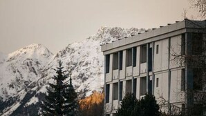A building with a modern architectural style, featuring a flat roof and a symmetrical facade with vertical windows. - Hotel Maistra 160, (Pontresina), by Interhome (Pontresina)