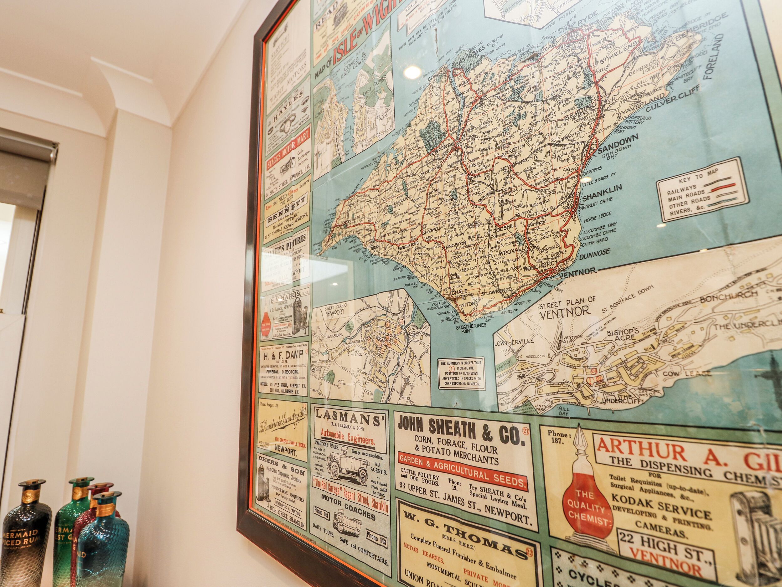 A vintage map with advertisements, including a motor coach service and funeral directors.