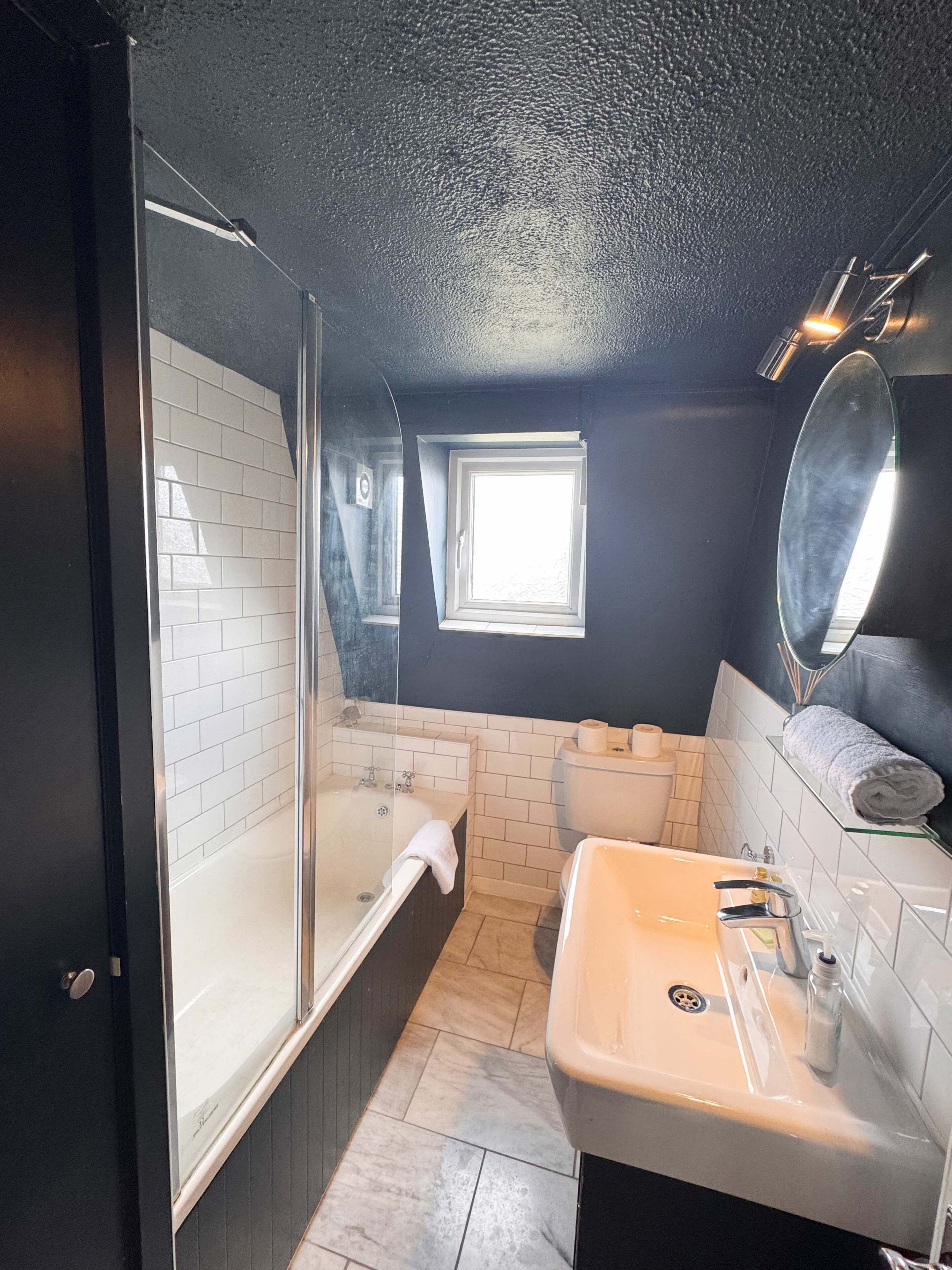 Shower, hair dryer, towels, shampoo