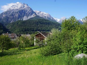 A mountain landscape with a wooden cabin and a clear sky. - Ferienhaus Chasa Allegra, (Scuol) by Interhome (Scuol)