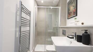 Shower, hair dryer, towels, shampoo