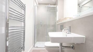 Shower, hair dryer, towels, shampoo