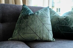A sofa with geometric-patterned cushions. - Grange Rd Flat 2 one bedroom flat (Bristol)