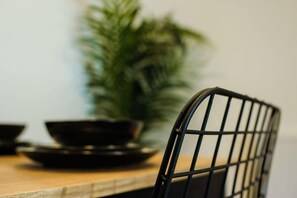 A dining table with a chair, a bowl, and a potted plant. - Hotwells apartments flat 7- Hopewell (Bristol)
