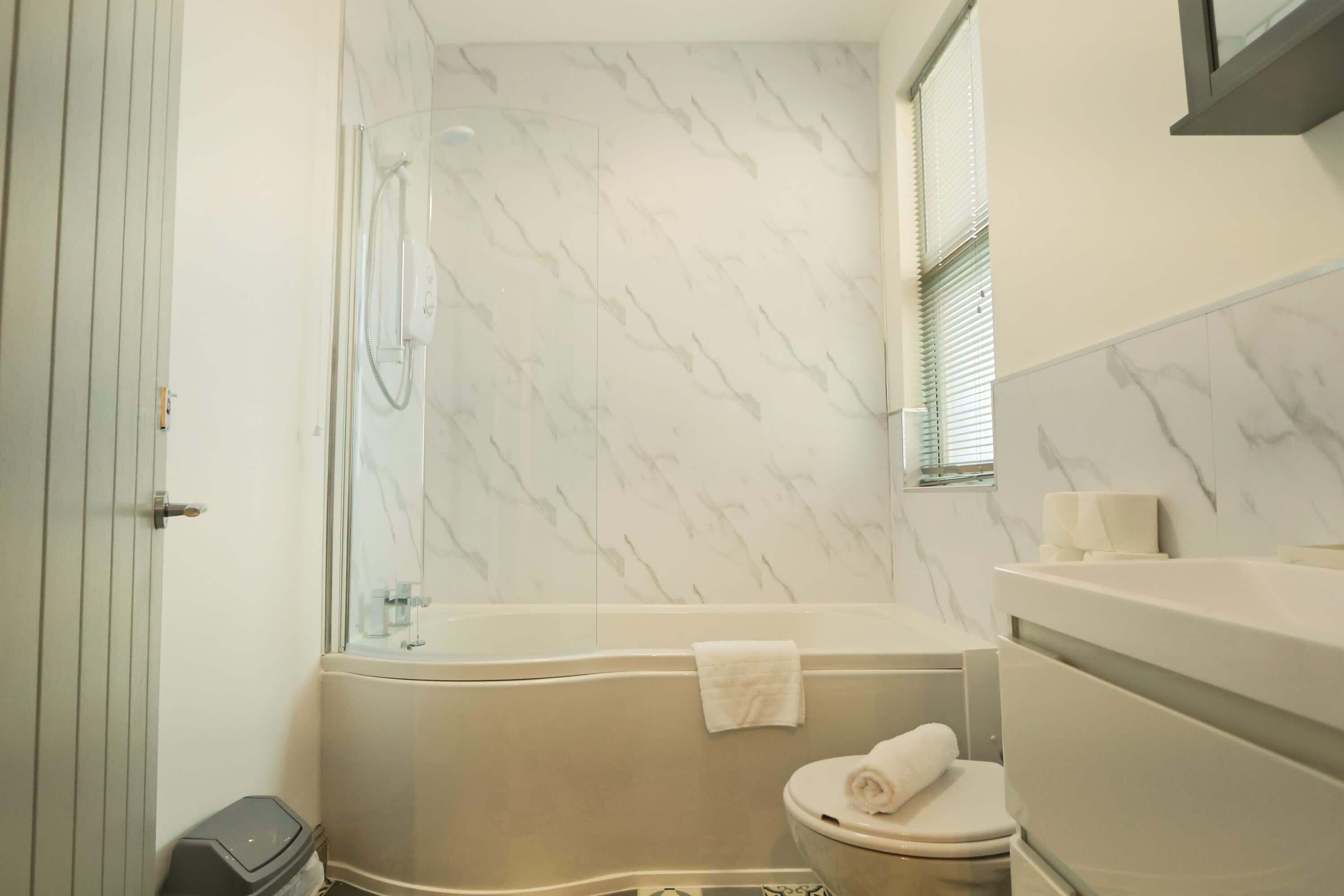 Shower, hair dryer, towels, shampoo