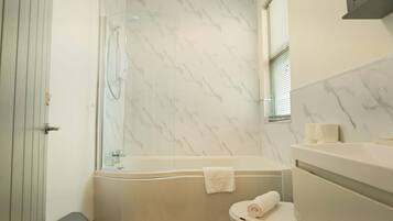 Shower, hair dryer, towels, shampoo