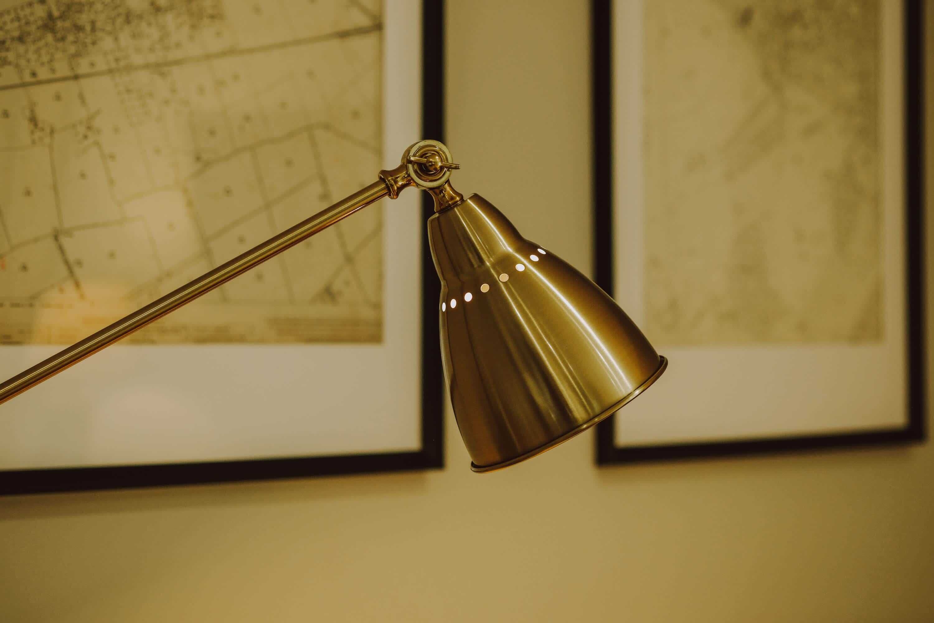 En skrivbordslampa med en metallisk yta och en enda glödlampa.