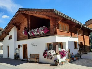 A chalet with a wooden facade, a balcony with flowers, and a sign reading 'Chalet Guardavall'. - Chalet Guardaval, (Samnaun-Compatsch) by Interhome (Samnaun)