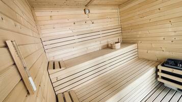A wooden sauna with benches, a wooden bench, and a small shelf with a clock.