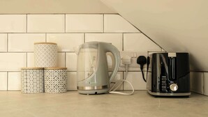 A kitchen with a kettle, a toaster, and patterned containers. - The Willow - Studio 14 (Patchway)