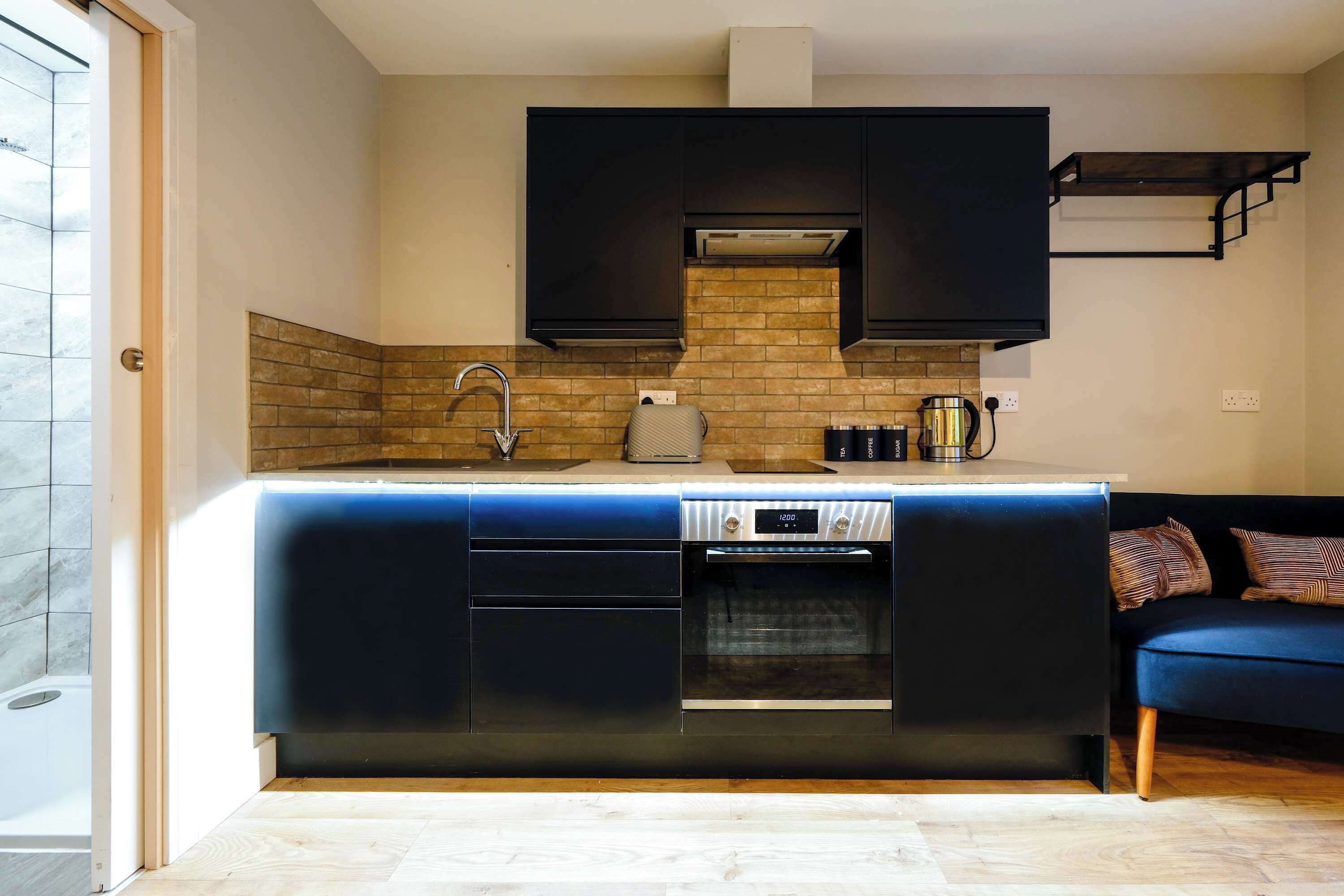 A modern kitchen with a built-in oven, a dishwasher, and a sink.