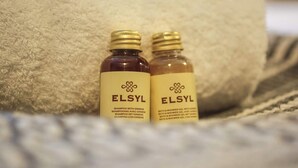 Two bottles of ELSYL shampoo and shower gel on a textured surface. - The Willow - Studio 27 (Patchway)