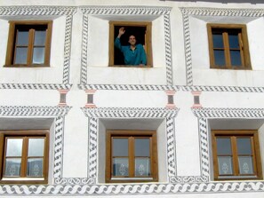 A building with multiple windows and decorative moldings. - Chasa Pitsch, (Tschierv) by Interhome (Tschierv)