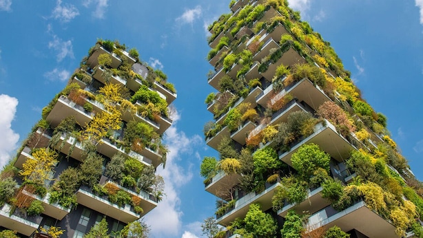Two high-rise buildings with balconies covered in greenery. - Unique Bosco Verticale Apartment: Live in the World's Icon (Milano)