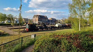 A train station with a stationary train, tracks, and a building in the background. - Bungalowpark Simpelveld - Schakel 16 by Interhome (Simpelveld)