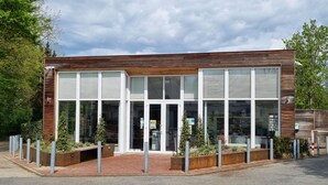 A modern building with large windows, a brick entrance, and metal bollards. - Bungalowpark Simpelveld - Schakel 16 by Interhome (Simpelveld)
