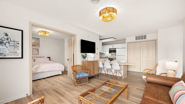 A modern apartment with a living room, dining area, kitchen, and a bedroom. - Villa Condo with Amenities and Short Beach Walk (Ocean City)