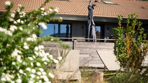 A building with a tiled roof, a wooden deck, and a metal railing. - Duplex Cottage Between Lake and Mountains in the High Vosges (Saulxures-sur-Moselotte)