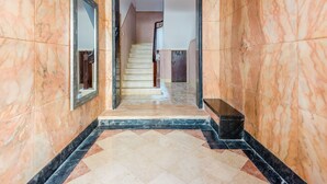A marble-floored hallway leading to a staircase. - Apartment  by Interhome (Lisbon)