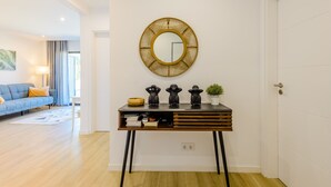 A modern living room with a sofa, a coffee table, and a lamp. - Apartment  by Interhome (Carvoeiro (Algarve))