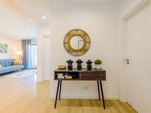 A modern living room with a sofa, a coffee table, and a lamp. - Apartment  by Interhome (Carvoeiro (Algarve))