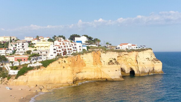 A coastal town with buildings on a cliff overlooking the sea. - Apartment  by Interhome (Carvoeiro (Algarve))