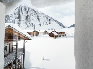 A snow-covered mountain landscape with wooden cabins. - Ferienhaus Isla, (Nufenen), by Interhome (Nufenen)