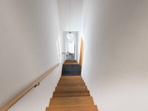 A staircase leading to a landing with a light fixture above. - Ferienhaus Isla, (Nufenen), by Interhome (Nufenen)