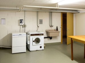 A laundry room with a washing machine, dryer, and a sink.