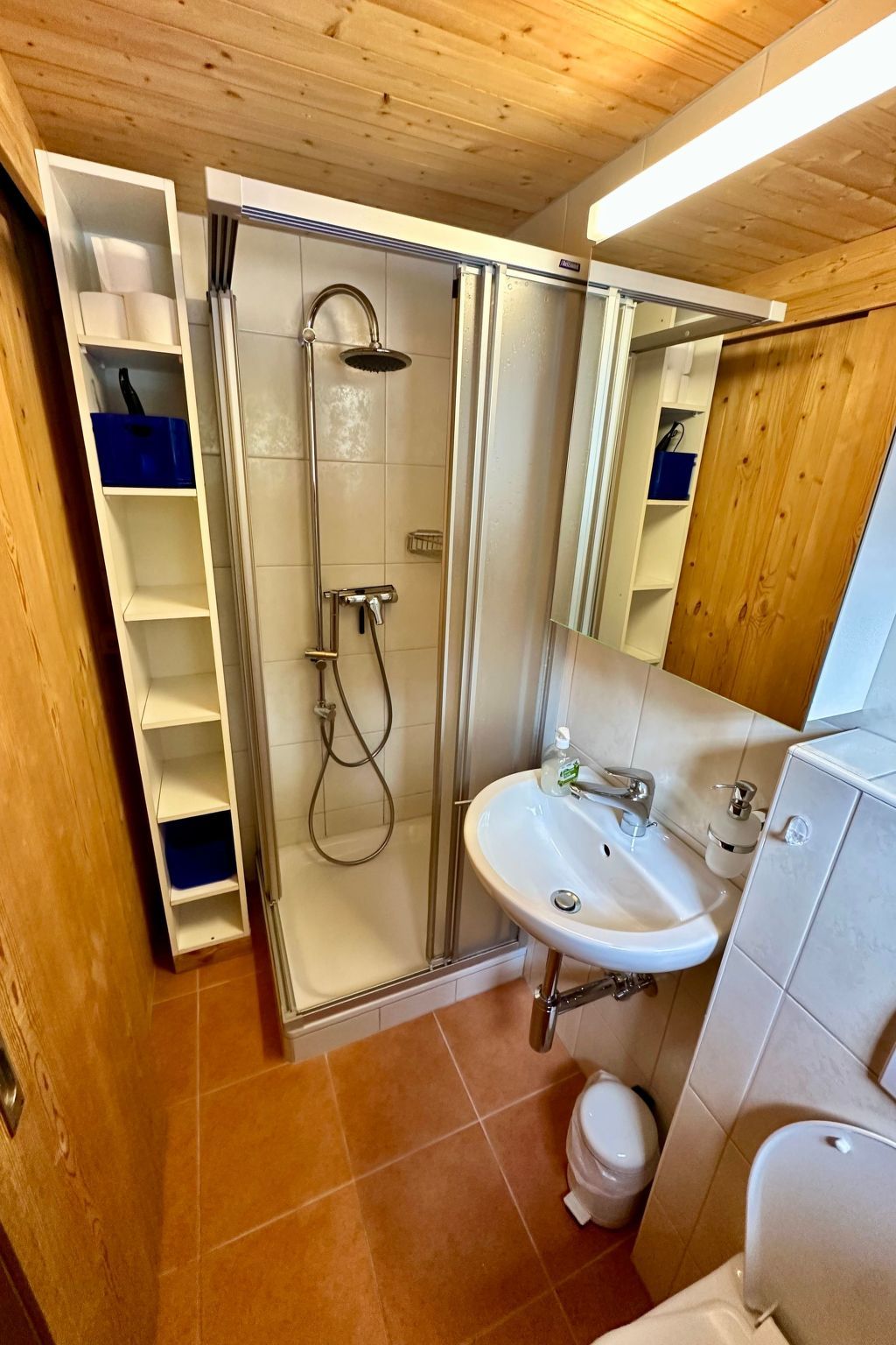 A bathroom with a shower, sink, and toilet.