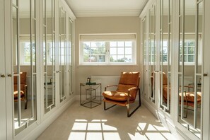 A room with a large window, a chair, and a radiator. - Sea Estate House (Littlehampton)