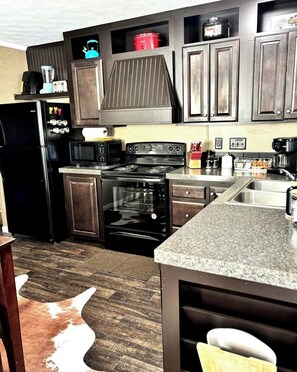 A kitchen with a refrigerator, stove, oven, microwave, and various appliances. - Welcome to The Lone Star Stay! Relaxing 3/2 family/group retreat near downtown! (Kirby)