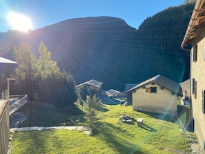 A rural setting with a house, a small building, and a fenced yard. - Ferienwohnungen Jörihus A&B, (Medels), by Interhome (Splügen)