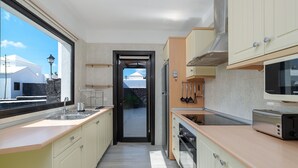 Een moderne keuken met uitzicht, een inbouwoven en een magnetron.